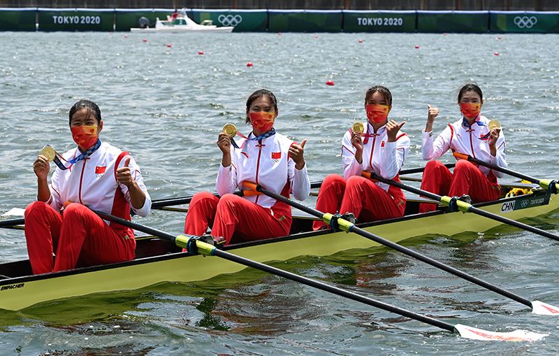 北京时间7月28日，东京奥运会赛艇女子四人双桨，中国队夺得金牌。图为颁奖仪式后，中国姑娘们佩戴金牌庆祝。人民日报报道团 王霞光摄