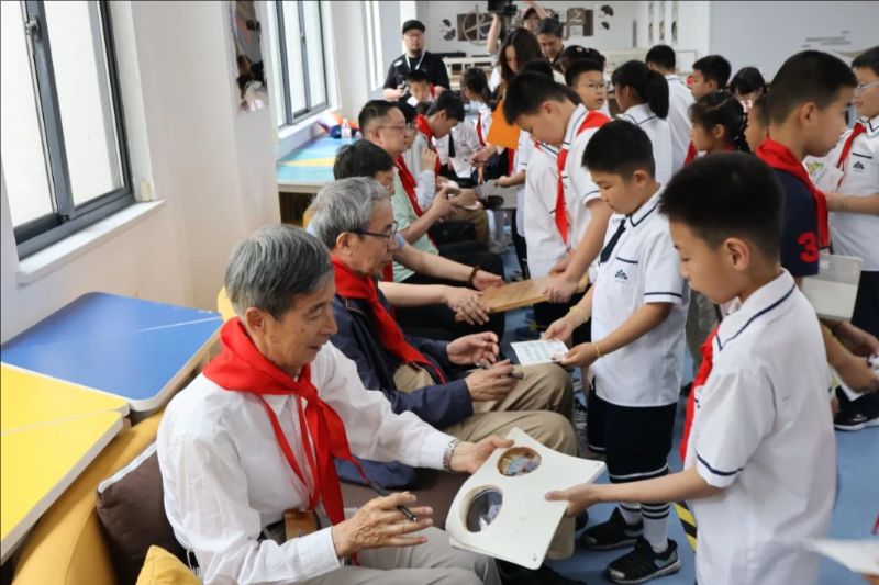 指导棋活动嘉宾给学生们签名。